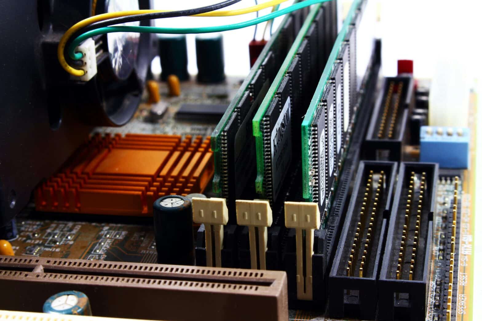 Close-up of computer hardware components with cables and circuit boards, illustrating best practices to prevent data loss from hardware failure.
